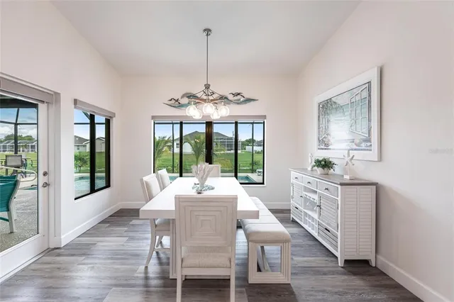 a view of a dining room with furniture wooden floor and chandelier