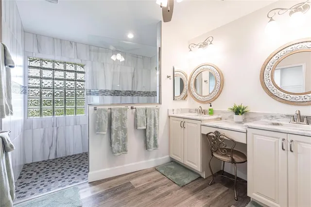 a spacious bathroom with a granite countertop sink and a mirror
