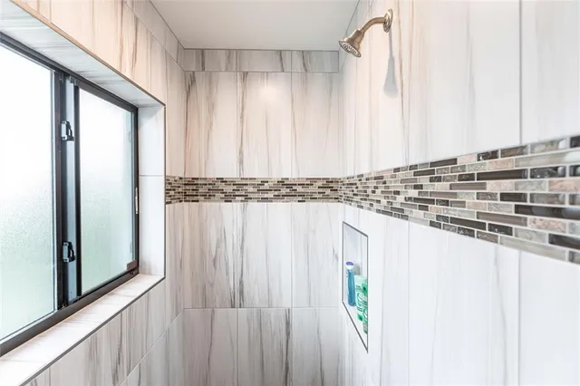 a bedroom with bed and a chandelier