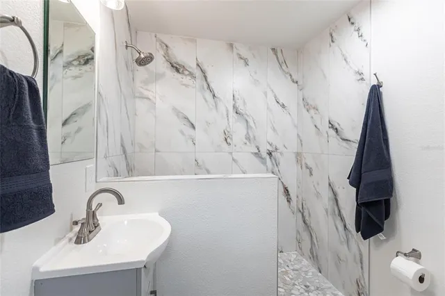 a hallway with painting and a potted plant