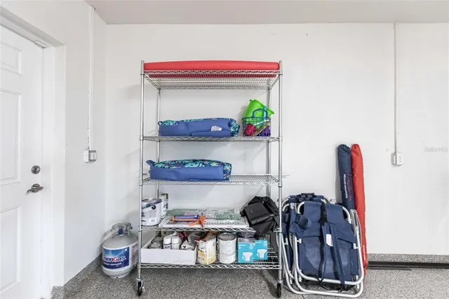 a view of a patio with a table chairs and a small yard