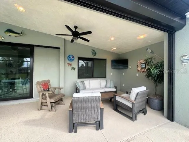 a view of a porch with furniture and yard fire pit and chairs