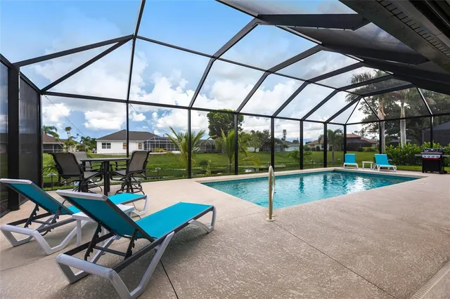 a view of a house with a yard and sitting area