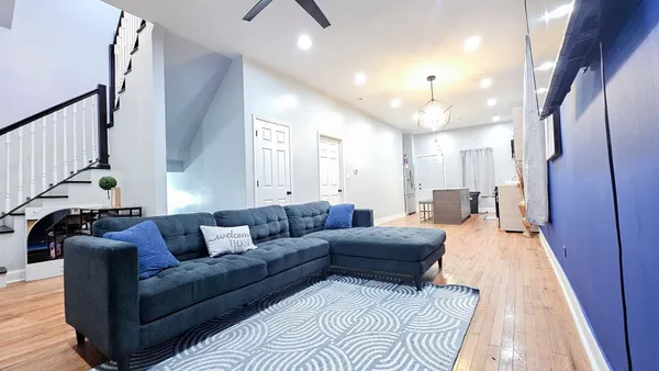 a living room with furniture and a chandelier