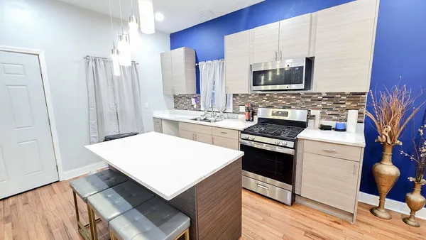 a kitchen with stainless steel appliances a stove a sink dishwasher and a refrigerator