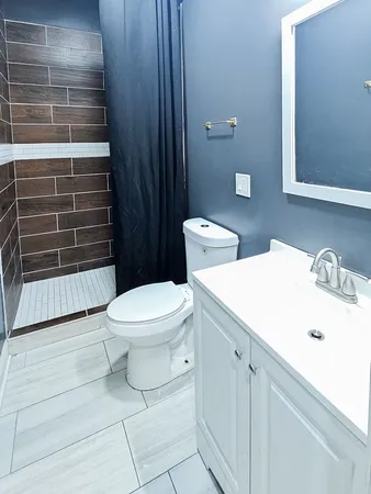 a bathroom with a toilet a sink and shower