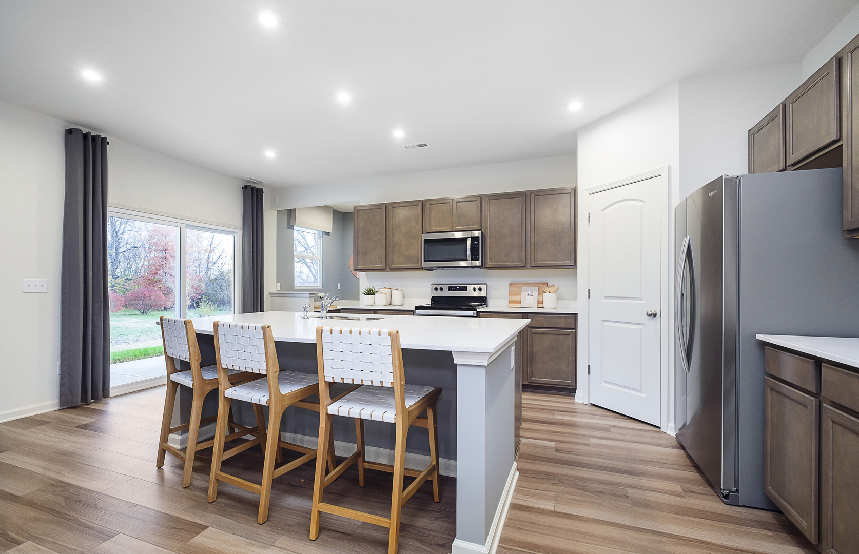 918 Houston Street Batavia, IL 60510 - Photo 3 of 20 a kitchen with microwave a refrigerator and wooden cabinets