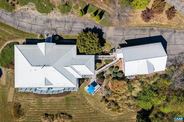a view of a house with a deck and a floor to ceiling window