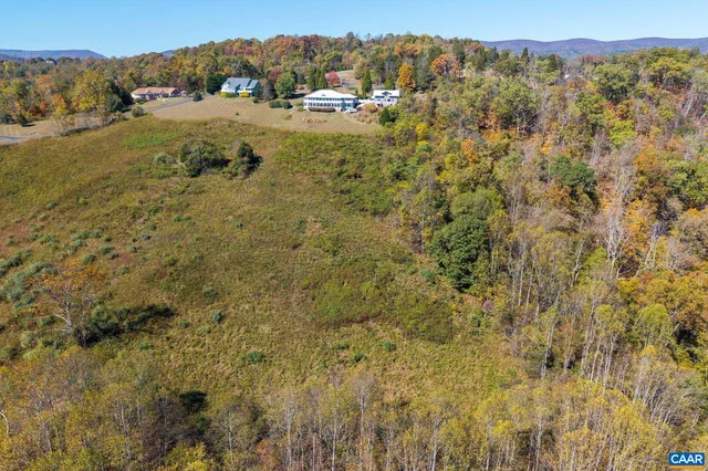 a view of a hallway and wooden floor and dining room