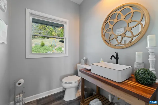 a spacious bedroom with a bed a table and large windows