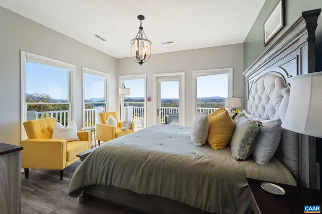 a view of a balcony with chairs and wooden floor