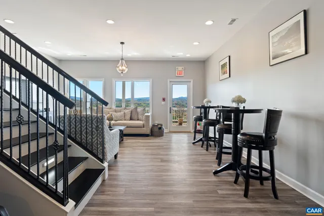 a kitchen with stainless steel appliances granite countertop a sink a stove and a wooden floors