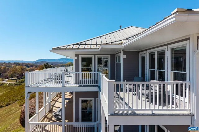 a front view of a house with a yard outdoor seating and garage