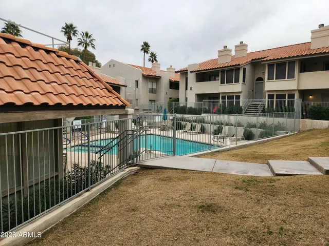 a view of residential houses with wooden fence