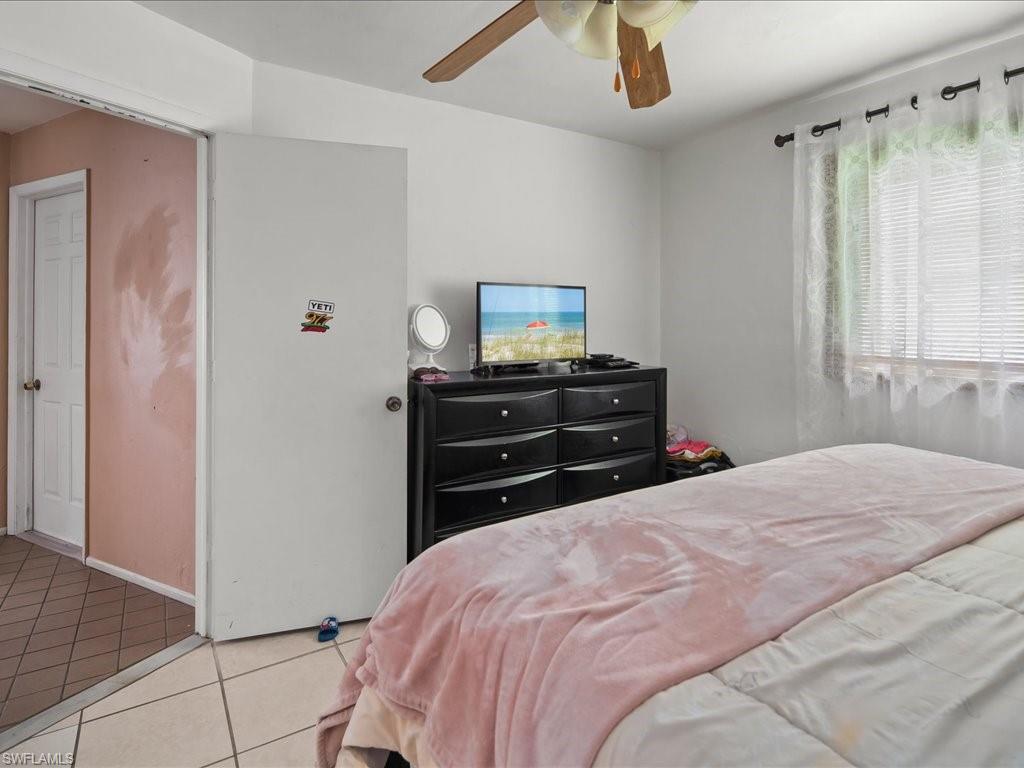 4865 22nd Avenue Southwest Naples, FL 34116 - Photo 11 of 20 a bedroom with a bed and a mirror