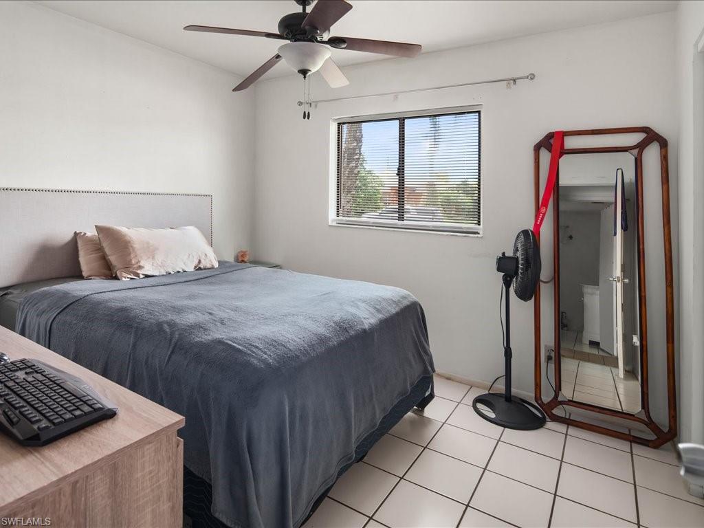 4865 22nd Avenue Southwest Naples, FL 34116 - Photo 14 of 20 a bedroom with a bed and a window
