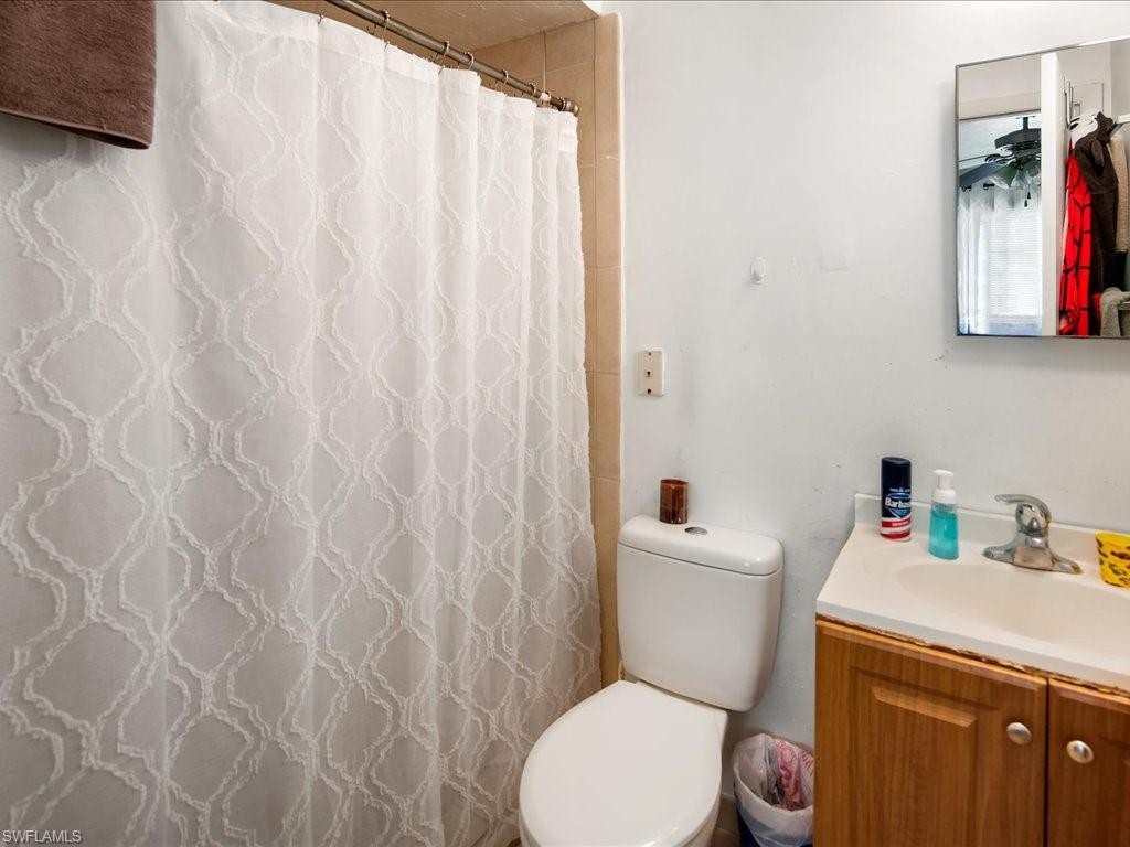 4865 22nd Avenue Southwest Naples, FL 34116 - Photo 16 of 20 a white toilet sitting next to a white sink and vanity