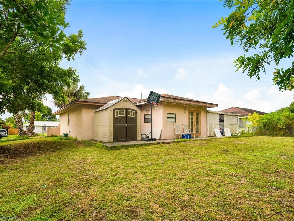4865 22nd Avenue Southwest Naples, FL 34116 - Photo 18 of 20 a large house with a big yard and large trees