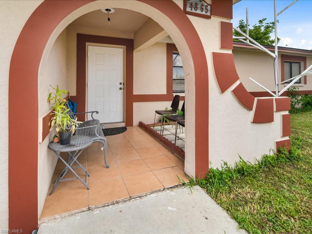 4865 22nd Avenue Southwest Naples, FL 34116 - Photo 2 of 20 a view of swimming pool with outdoor seating