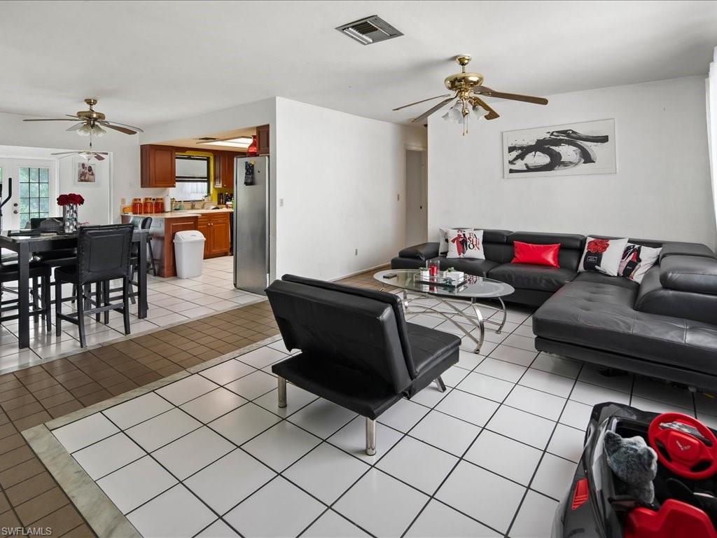 4865 22nd Avenue Southwest Naples, FL 34116 - Photo 3 of 20 a living room with furniture and a table