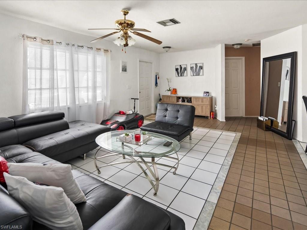 4865 22nd Avenue Southwest Naples, FL 34116 - Photo 4 of 20 a living room with furniture gym equipment and a window