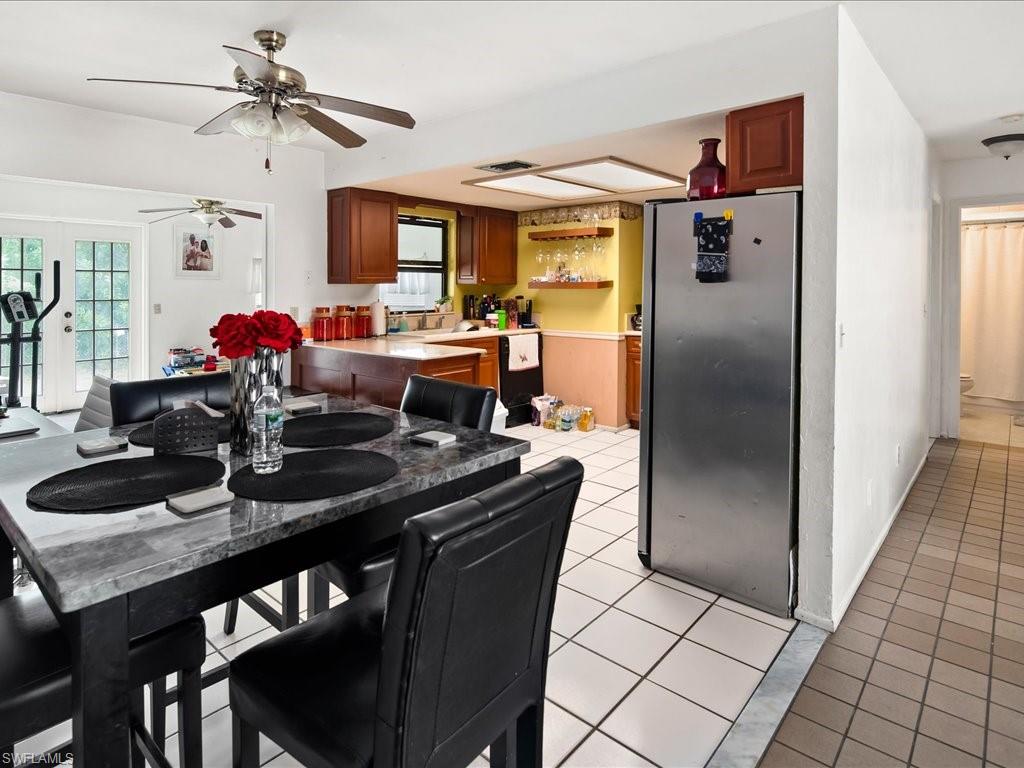 4865 22nd Avenue Southwest Naples, FL 34116 - Photo 5 of 20 a view of a dining room with furniture and a chandelier