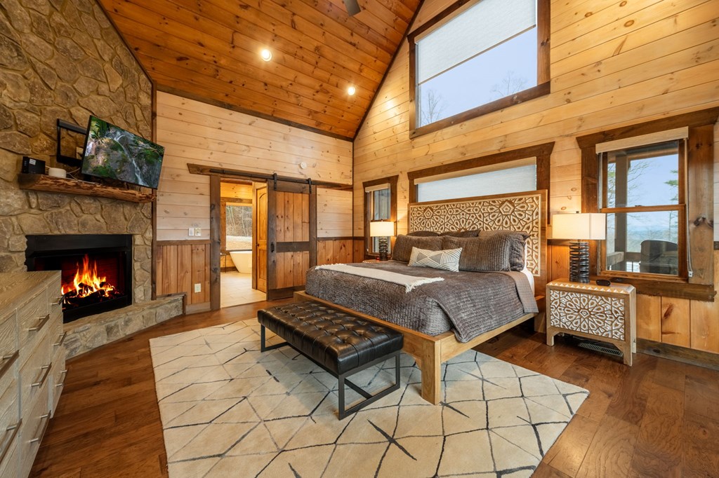 120 Riverview Drive Blue Ridge, GA 30513 - Photo 23 of 68 a bed room with a bed and a fireplace