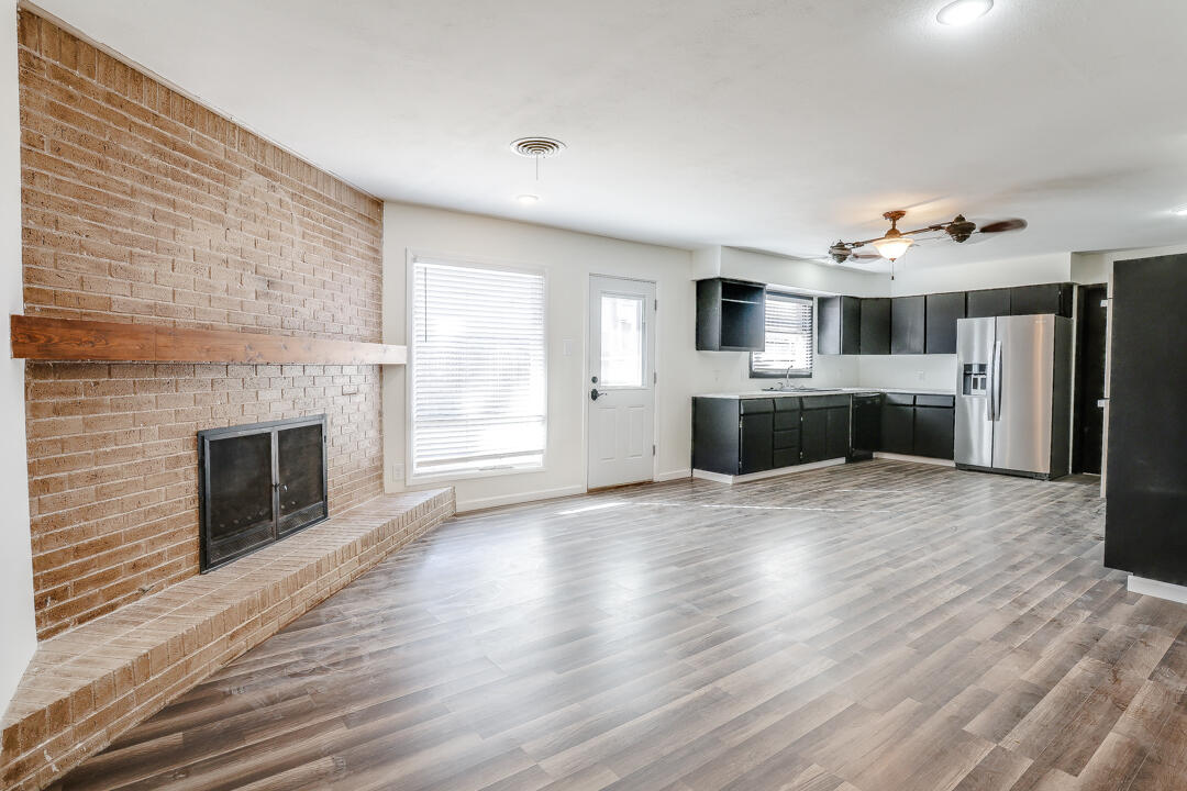 2123 66th Street Lubbock, TX 79412 - Photo 5 of 16 a view of a kitchen with a sink and a stove top oven