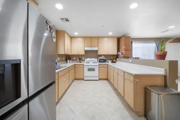 a kitchen with cabinets a sink and appliances