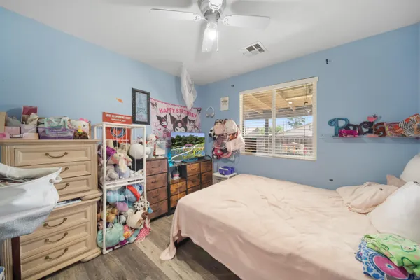 a bedroom with a bed and a chandelier