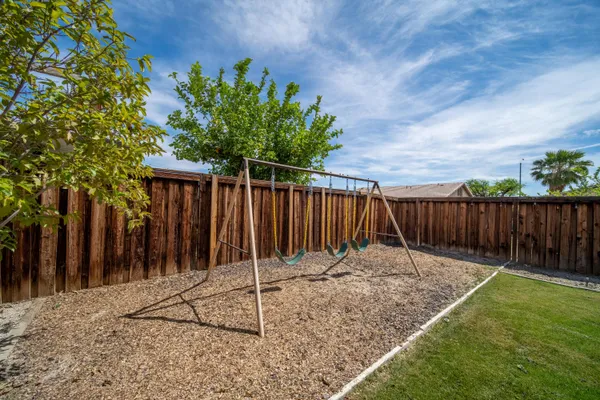 a view of a porch with furniture and a yard