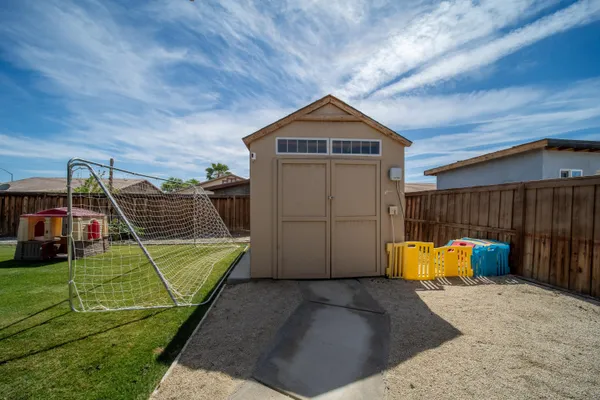 a backyard of a house with table and chairs