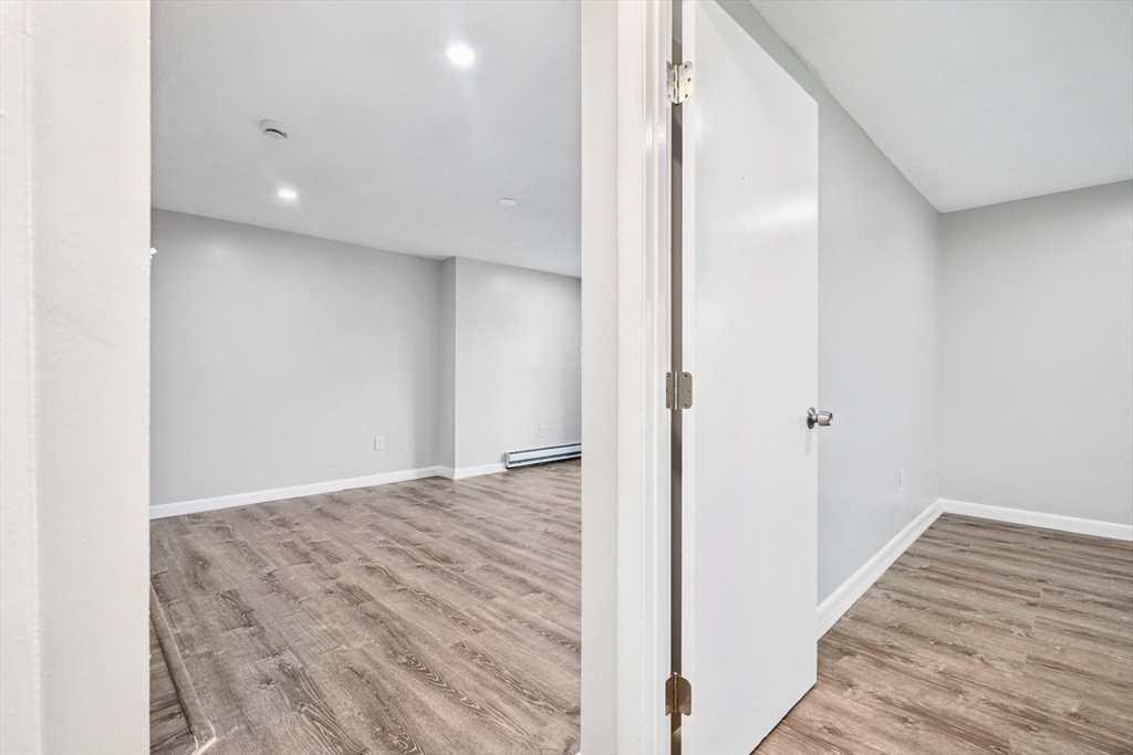 770 Cummins Highway, Unit 22 Boston, MA 02126 - Photo 12 of 28 a view of a hallway with wooden floor