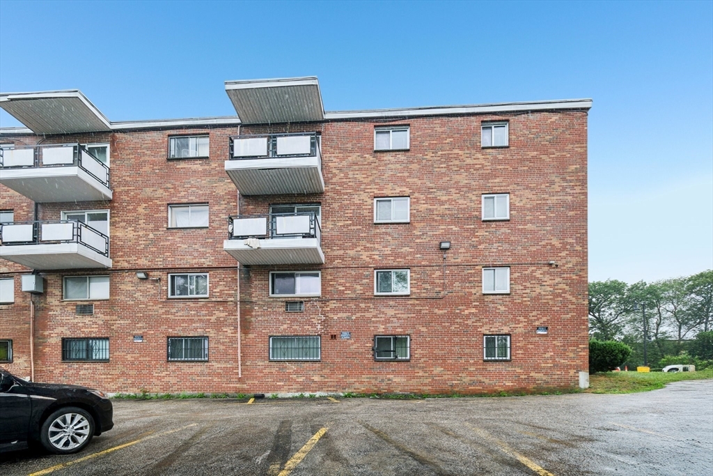 770 Cummins Highway, Unit 22 Boston, MA 02126 - Photo 17 of 28 a front view of a building with parking space