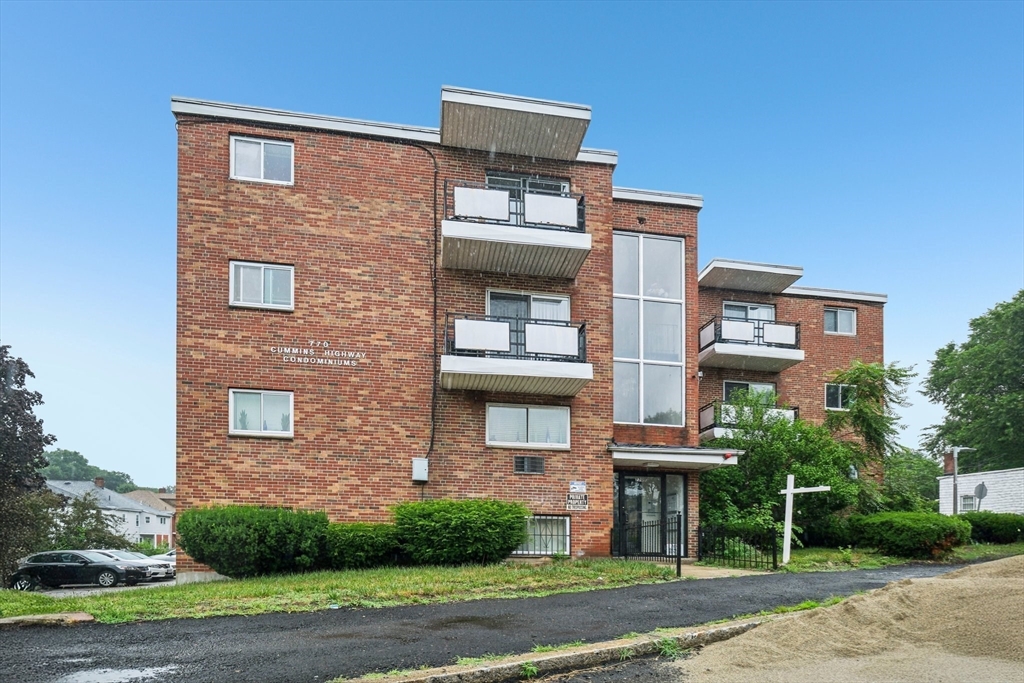 770 Cummins Highway, Unit 22 Boston, MA 02126 - Photo 19 of 28 a front view of a house with a yard