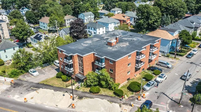 an aerial view of a house with outdoor space