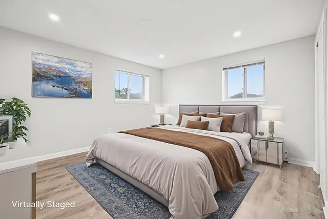 a bedroom with bed and wall painting