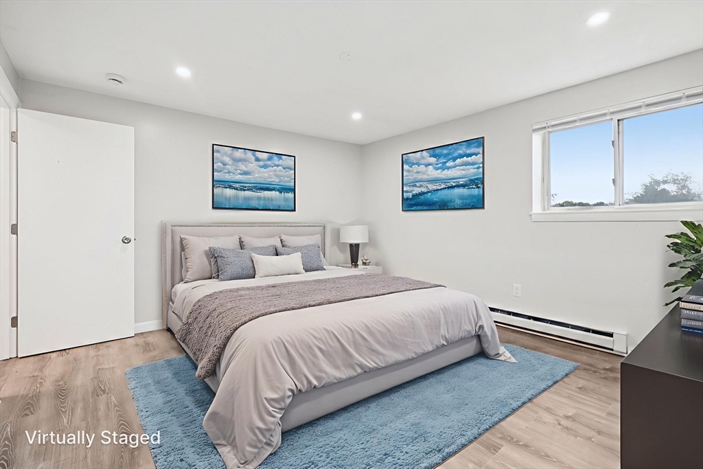 770 Cummins Highway, Unit 22 Boston, MA 02126 - Photo 4 of 28 a bedroom with bed and window