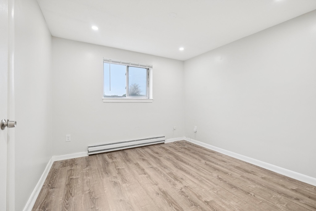 770 Cummins Highway, Unit 22 Boston, MA 02126 - Photo 9 of 28 an empty room with a workbench
