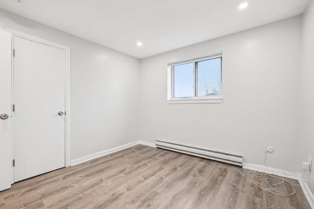 770 Cummins Highway, Unit 22 Boston, MA 02126 - Photo 10 of 28 wooden floor in an empty room