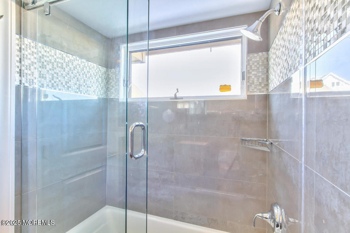 1926 Oceanfront, Unit 14 Seaside Heights, NJ 08751 - Photo 20 of 21 a bathroom with a shower and a window