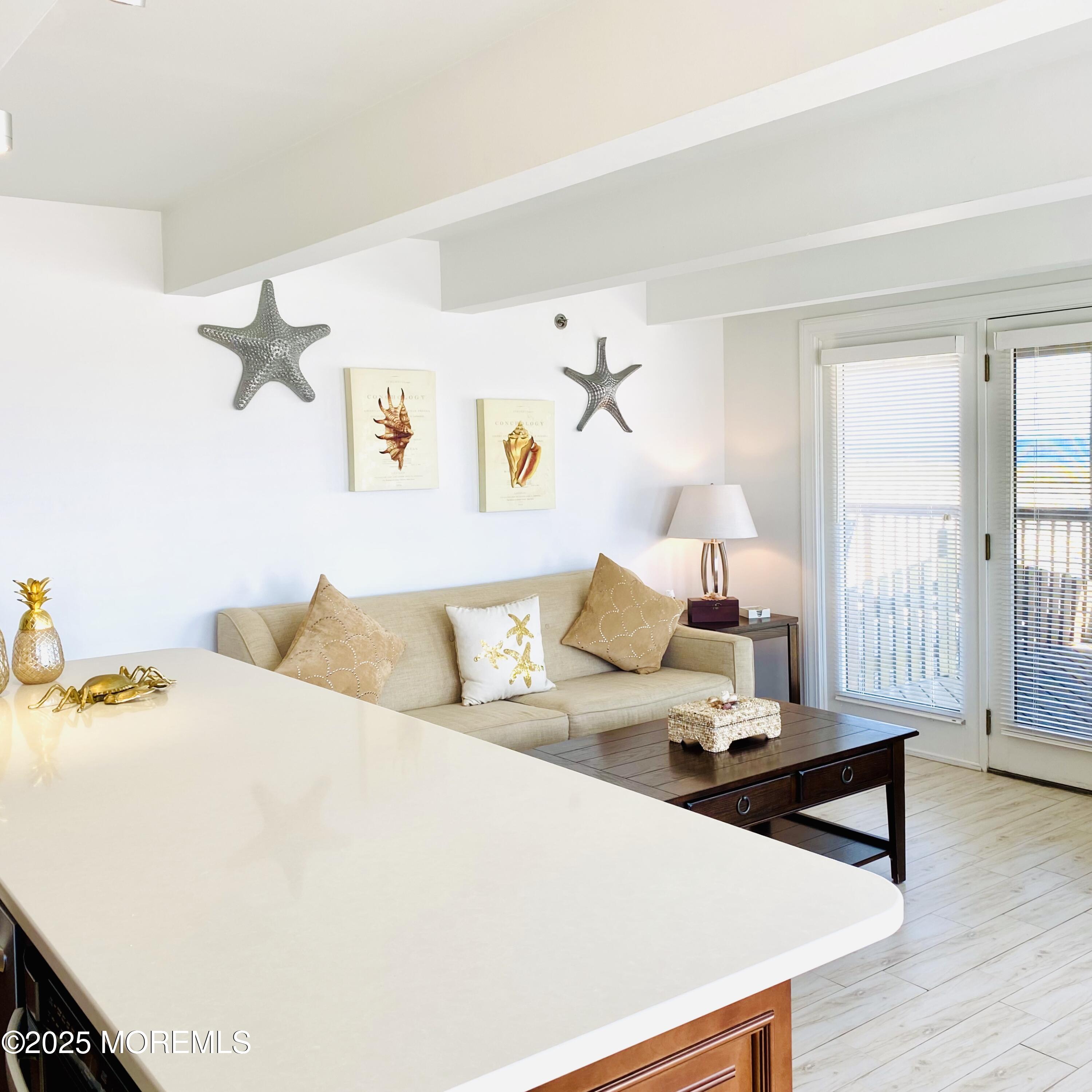 1926 Oceanfront, Unit 14 Seaside Heights, NJ 08751 - Photo 3 of 21 a bedroom with a bed and wooden floor