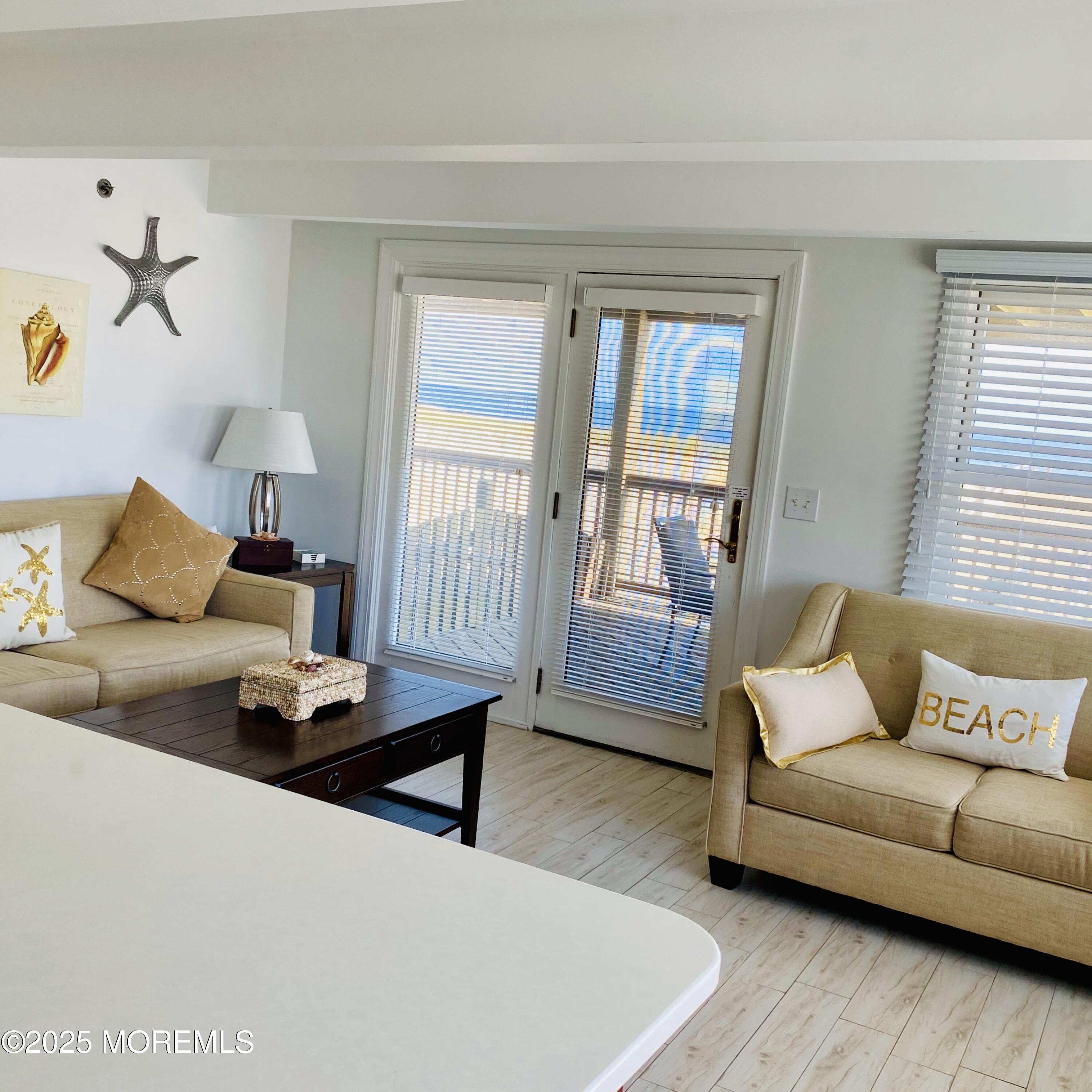 1926 Oceanfront, Unit 14 Seaside Heights, NJ 08751 - Photo 7 of 21 a living room with furniture and a window