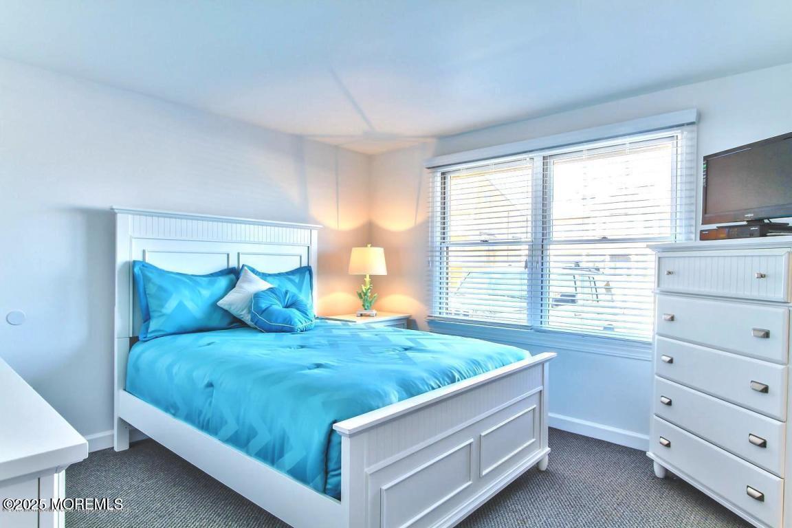1926 Oceanfront, Unit 14 Seaside Heights, NJ 08751 - Photo 10 of 21 a bed room with a bed and a window