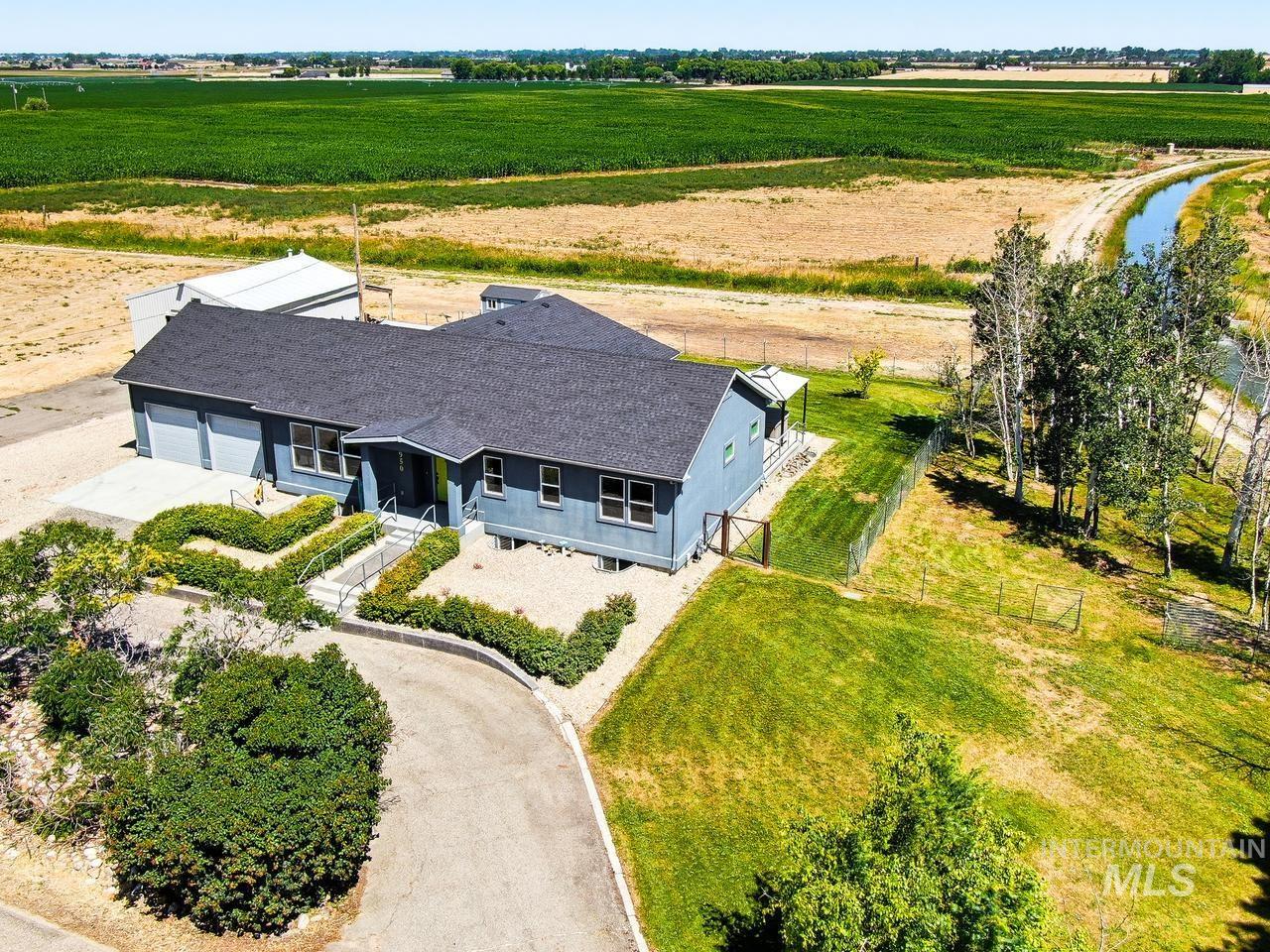 4950 West Columbia Road Nampa, ID 83687 - Photo 50 of 50 Single-story residence featuring a dark shingle roof, light blue siding, and a prominent two-car garage