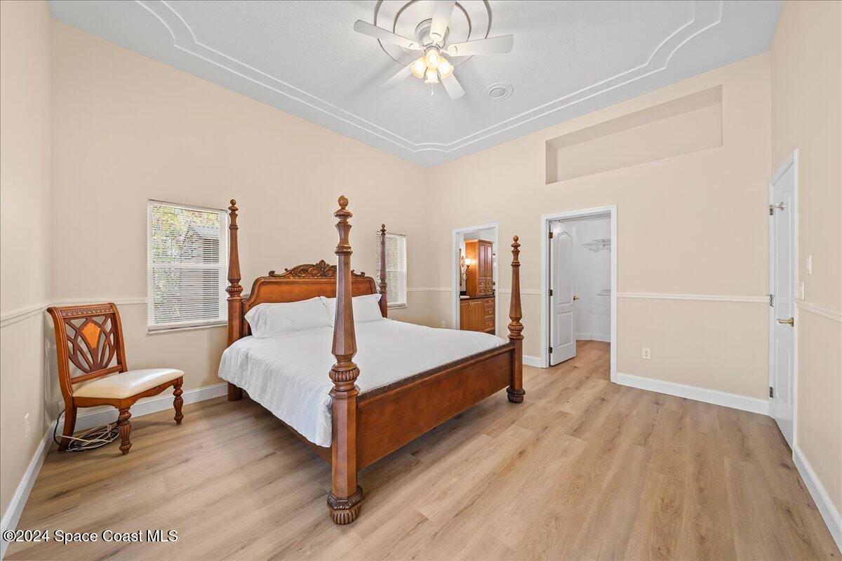 4360 Canard Road Melbourne, FL 32934 - Photo 12 of 54 a bedroom with a bed and a chandelier