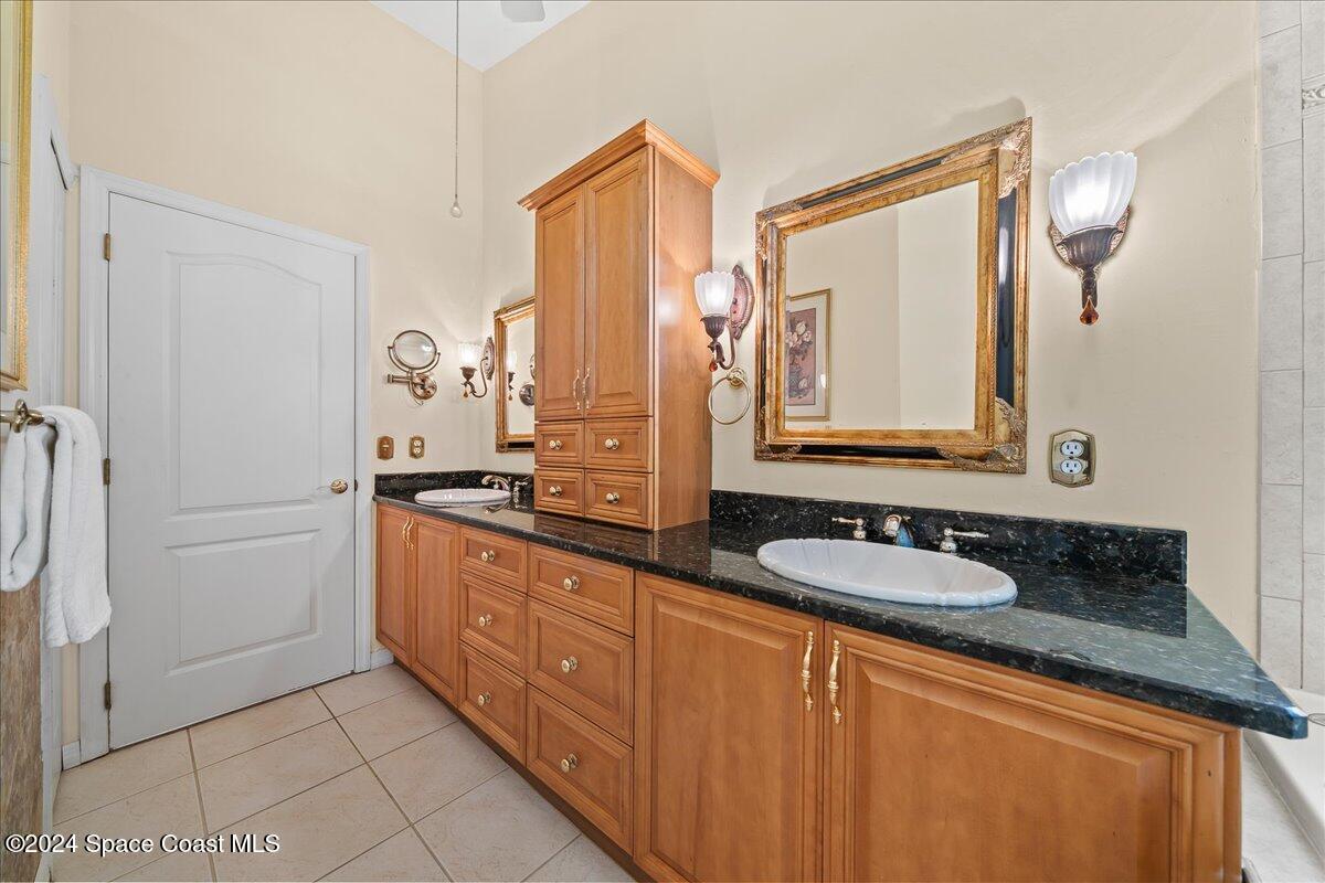 4360 Canard Road Melbourne, FL 32934 - Photo 14 of 54 a bathroom with a granite countertop sink and a mirror