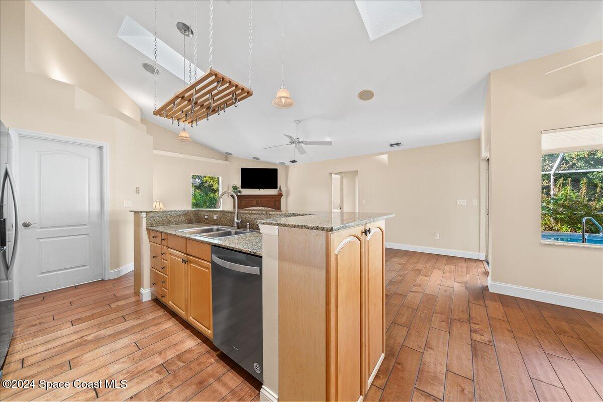 4360 Canard Road Melbourne, FL 32934 - Photo 18 of 54 a kitchen with kitchen island stainless steel appliances a stove top oven and a refrigerator