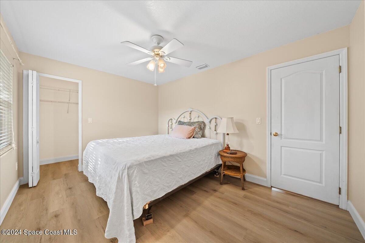 4360 Canard Road Melbourne, FL 32934 - Photo 27 of 54 a bedroom with a bed and a chandelier