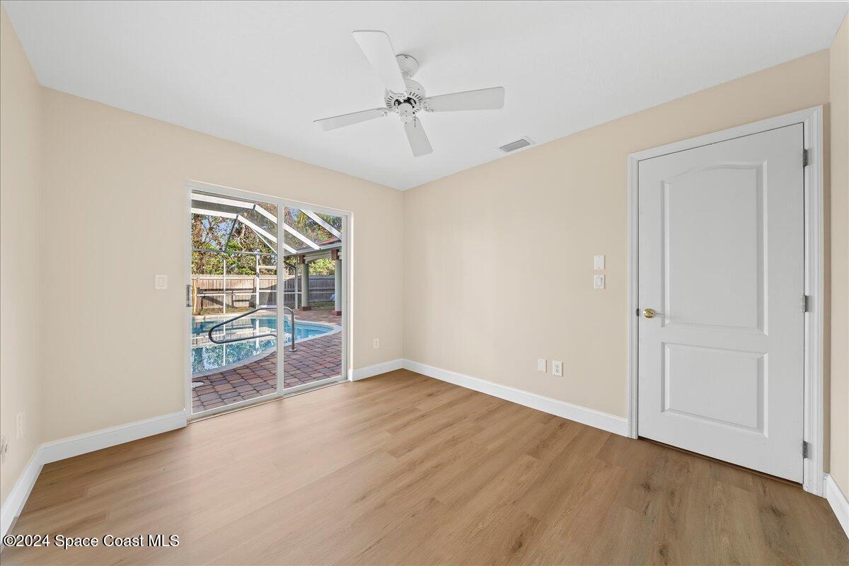 4360 Canard Road Melbourne, FL 32934 - Photo 28 of 54 an empty room with wooden floor fan and windows